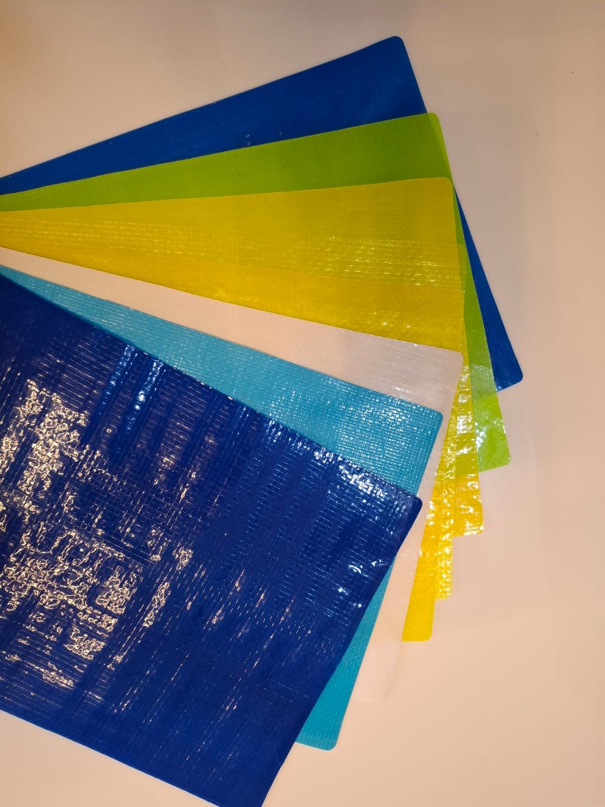 Folded orange-yellow HDPE tarpaulin from the size chart